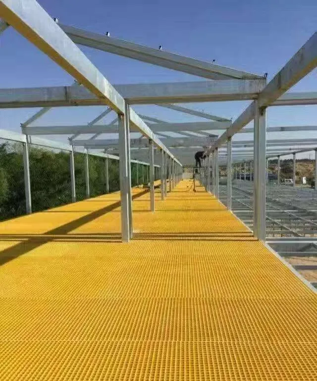 Yellow molded FRP walkway grating carried on a steel support frame