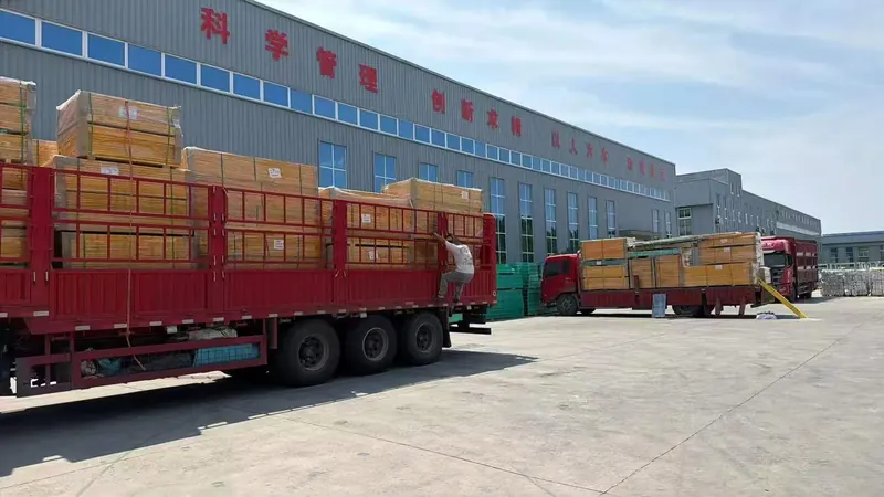 Wrapped FRP grating panels loaded on trucks outside the factory
