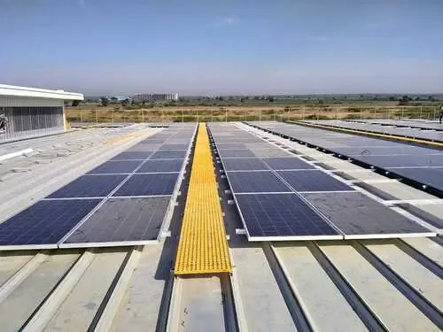 Yellow grating maintenance walkway beside solar panels