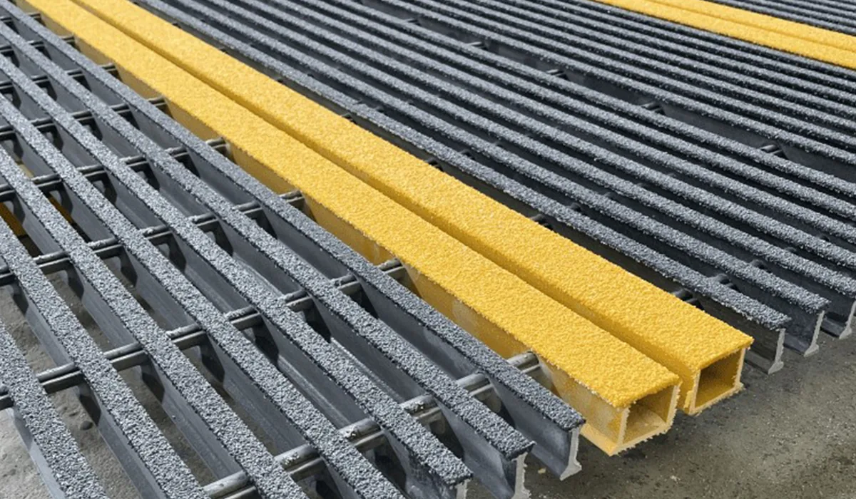 Gray pultruded FRP grating and yellow profiles with textured surfaces