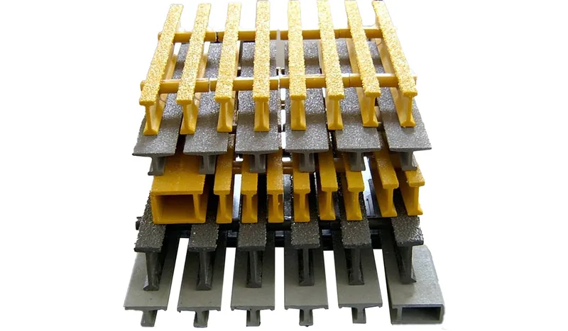 Stacked yellow and gray pultruded grating samples showing bearing-bar ends and connecting cross rods