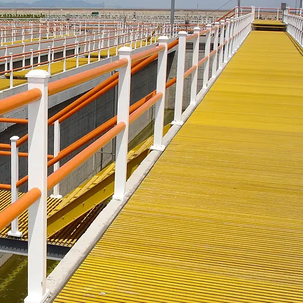 Yellow pultruded FRP grating walkway with white and orange handrails