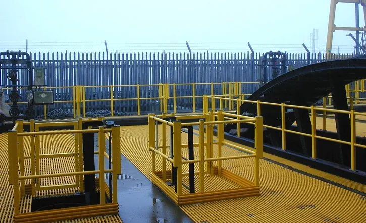 Yellow FRP grating access platforms and handrails around treatment equipment
