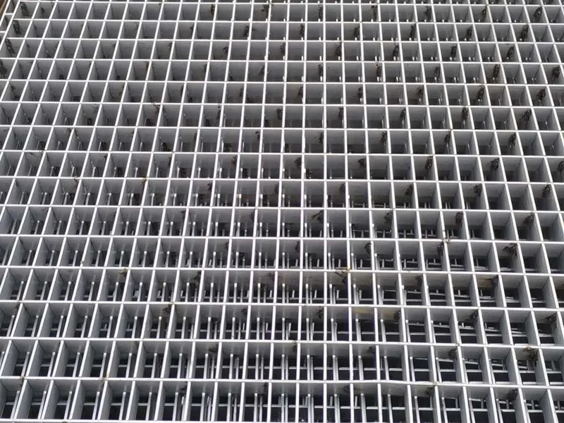 Stacked steel bar grating panels on site before installation